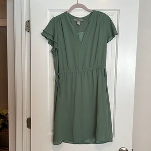 Green dress with ruffle sleeves. Warn one time